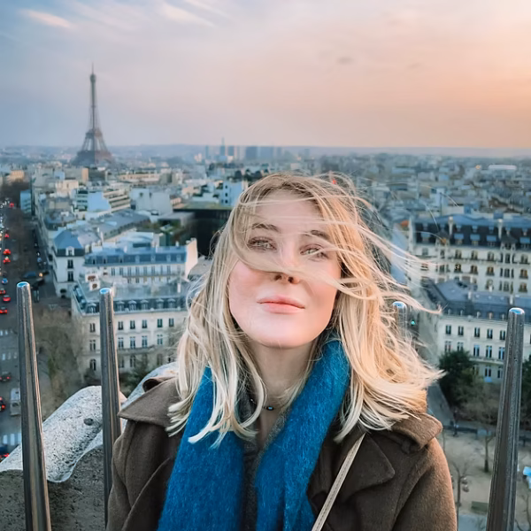 Sofia Chukovskaia, author of SofiaCh', on a rooftop in Paris with the Eiffel Tower behind her